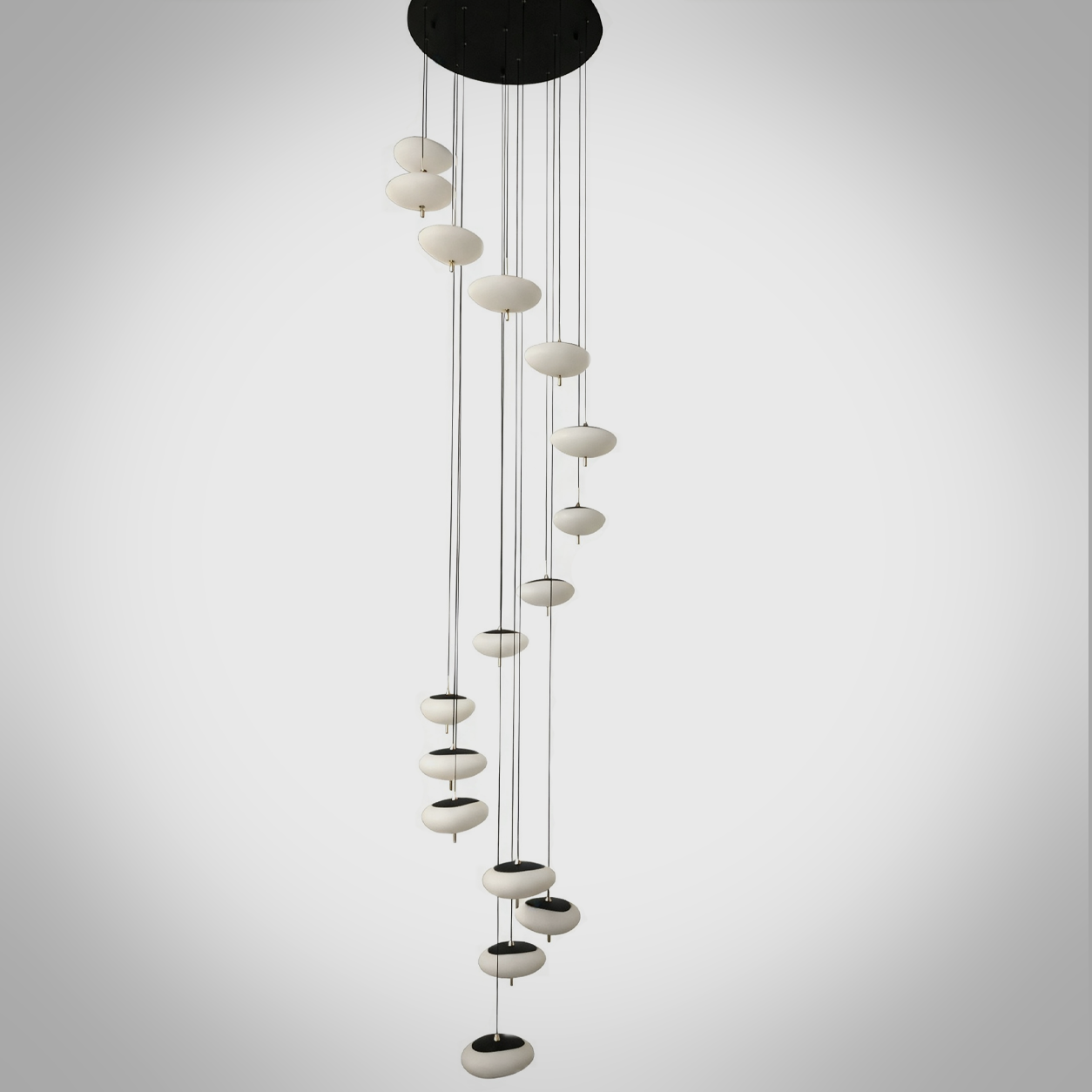Modern spiral pebble optical acrylic staircase chandelier cascading down a high ceiling foyer