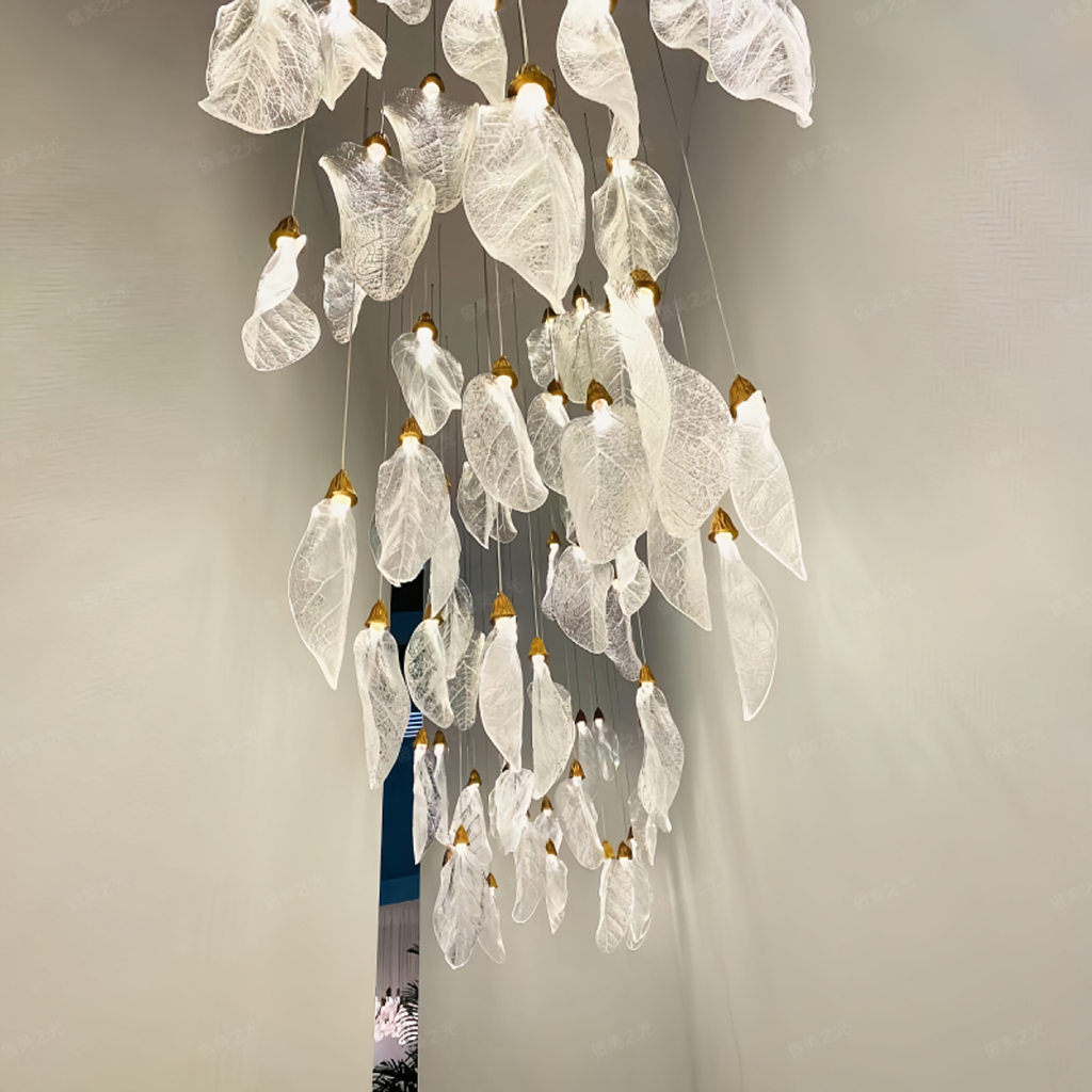 Close-up of sculpted optical acrylic leaf blade showing realistic leaf vein textures and flower-bud cap light source on a luxury chandelier