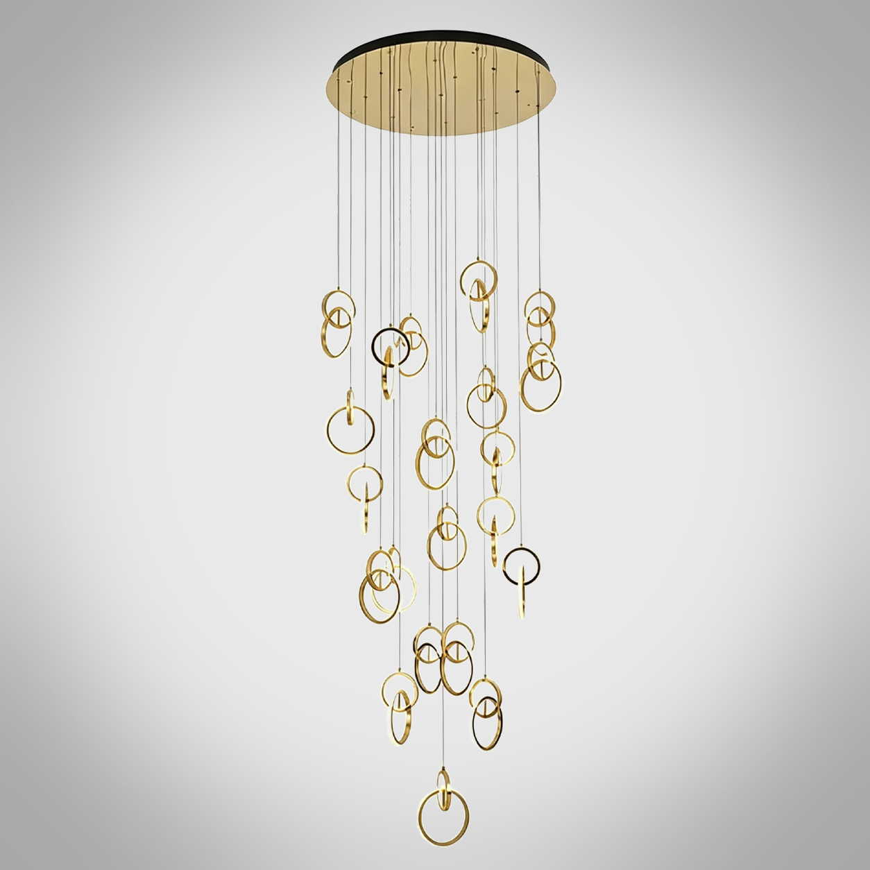 Modern gold stainless steel interlocking ring cascade chandelier suspended in a high ceiling villa foyer