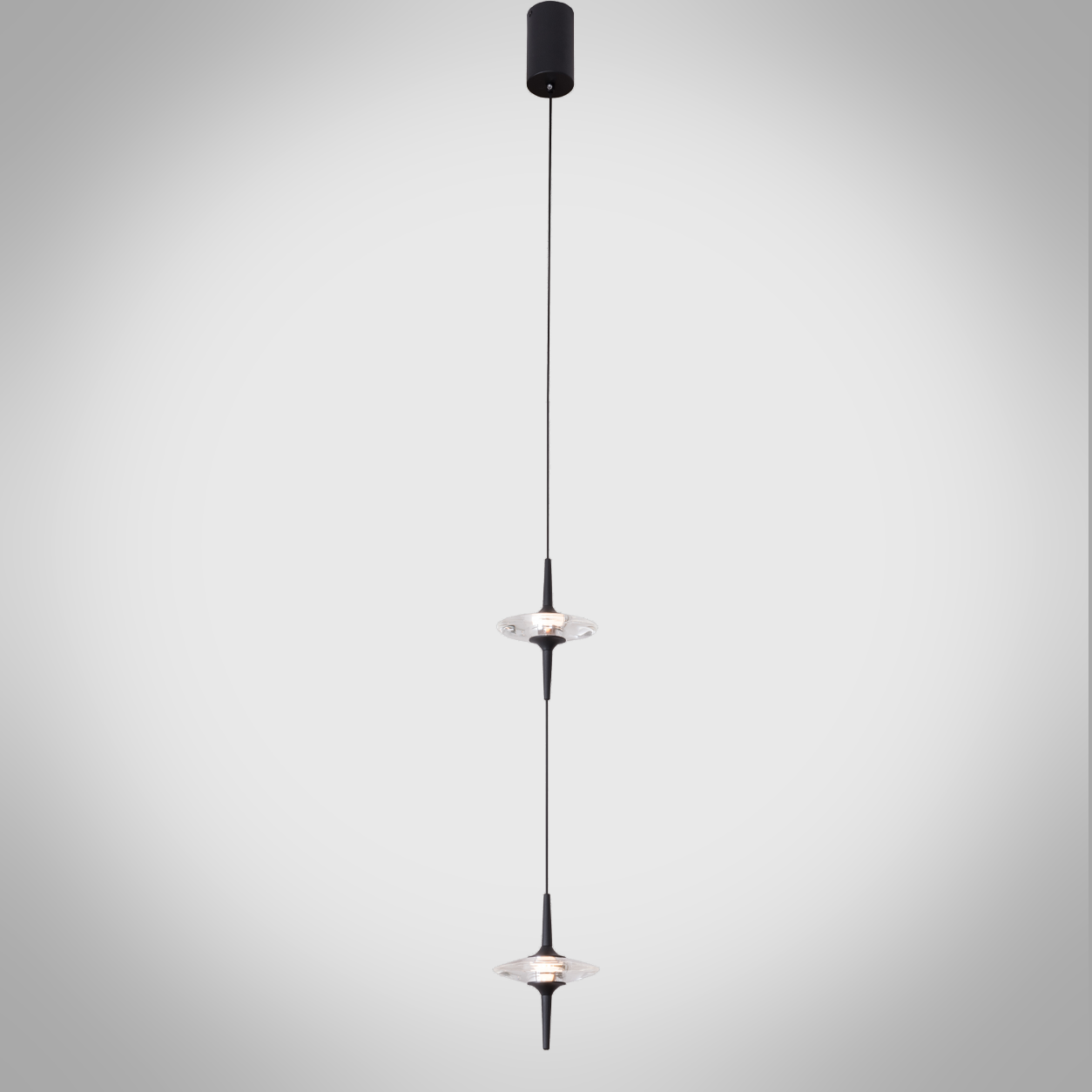 Two staggered black aluminum ufo crystal pendant lights hanging gracefully over a modern wooden dining table