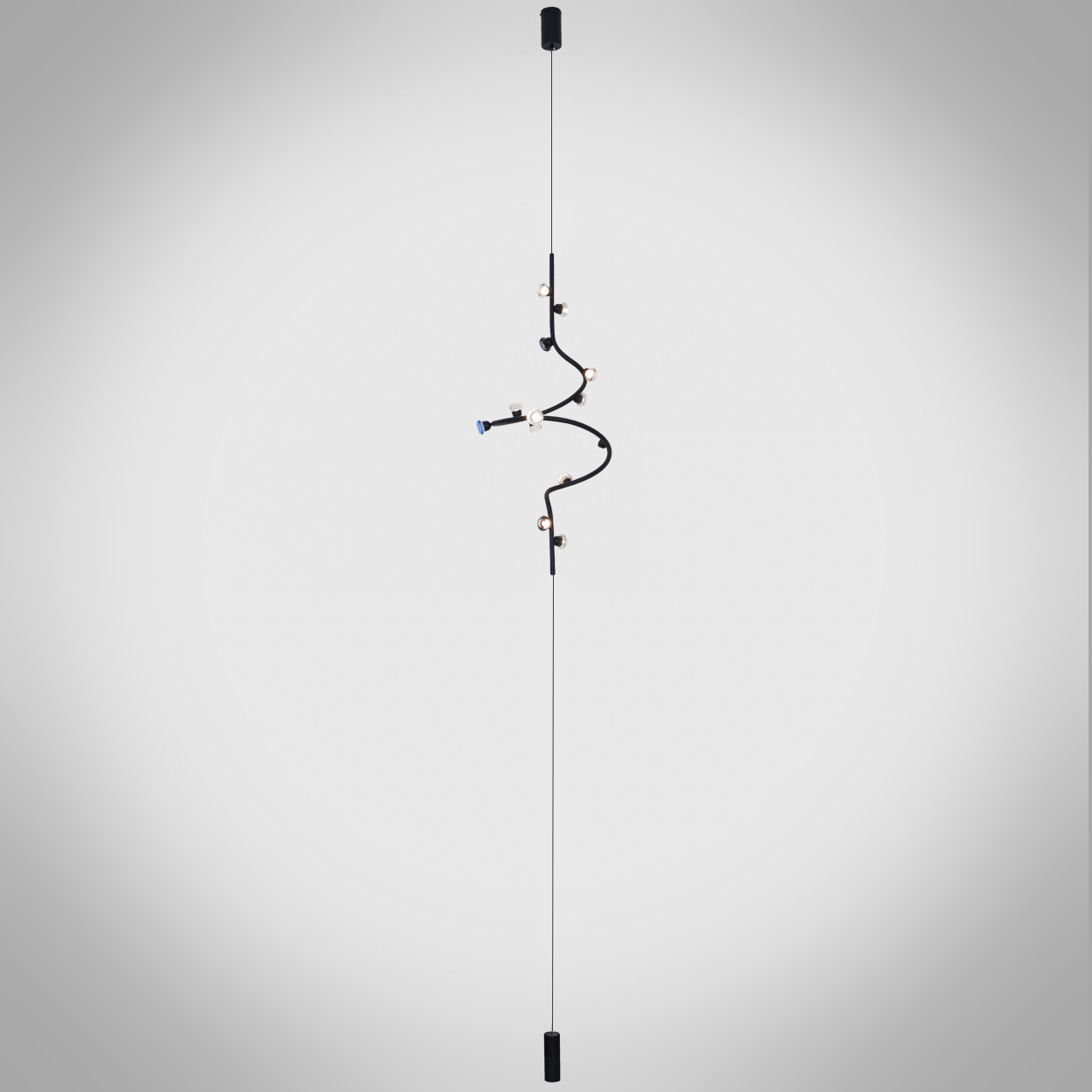 Modern vertical spiral cable chandelier suspended next to a luxury sofa in a contemporary living room with iron and aluminum construction
