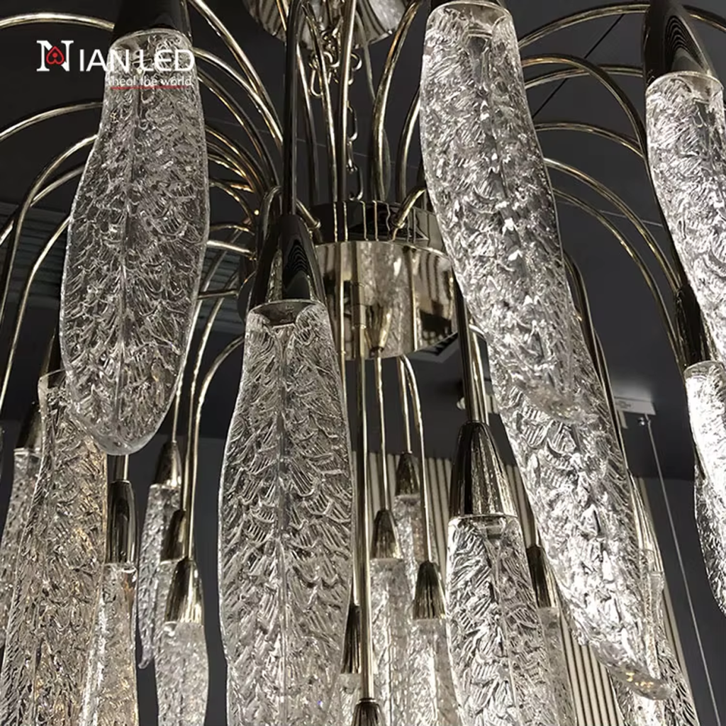 Close-up of textured optical acrylic feather leaf pods with zinc alloy hardware on a steel frame chandelier