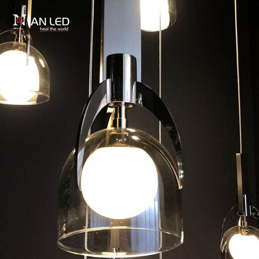 Close-up of double-layer glass shade, marble block, and mirror brown stainless steel arch frame on a luxury pendant chandelier