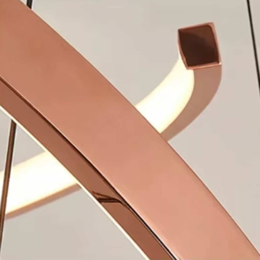 Close-up of square-tubing rose gold mirror polished stainless steel frame and integrated LED diffuser strip
