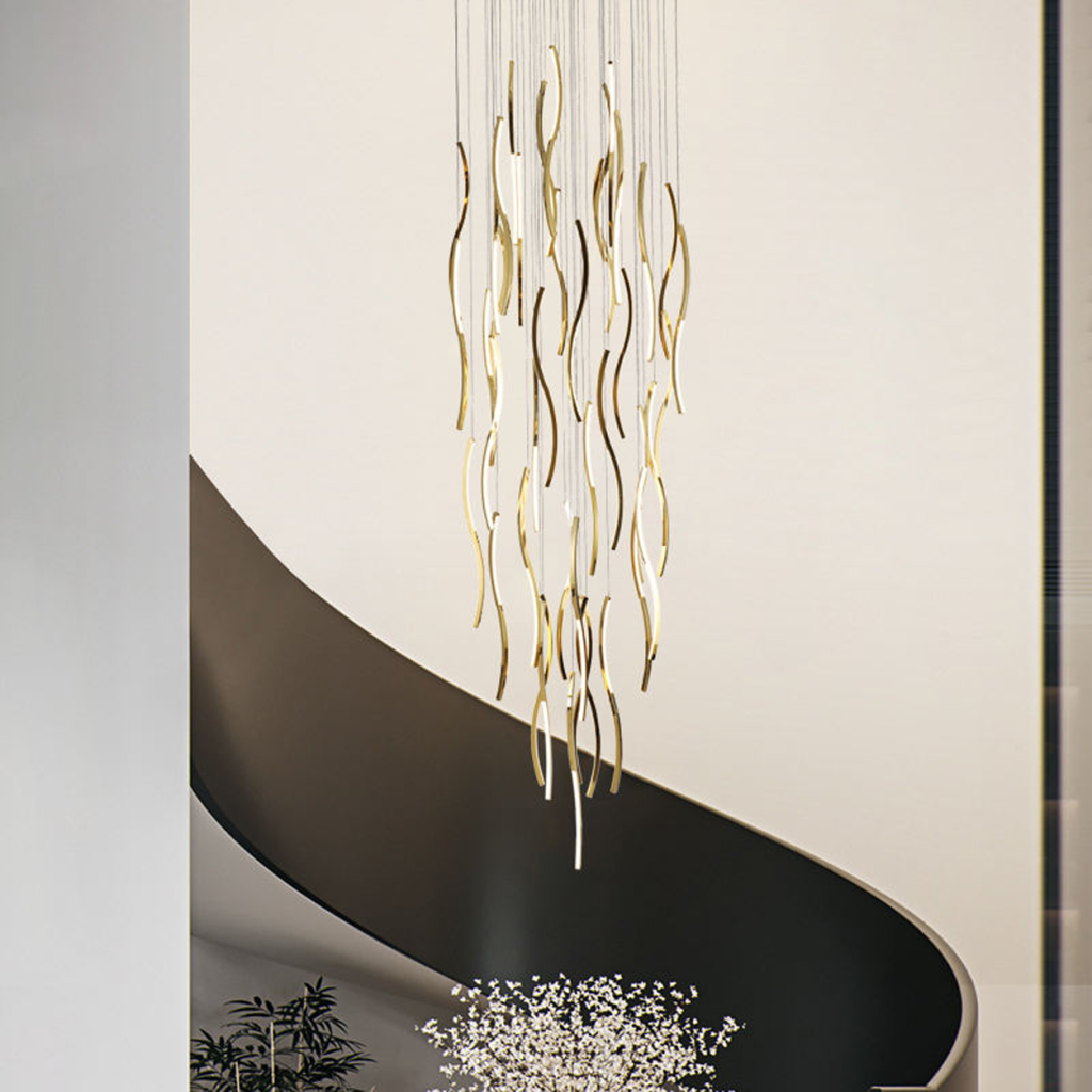 Modern gold polished stainless steel wave streamer raindrop chandelier suspended in a high ceiling villa foyer