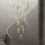 Modern gold stainless steel interlocking ring cascade chandelier suspended in a high ceiling villa foyer