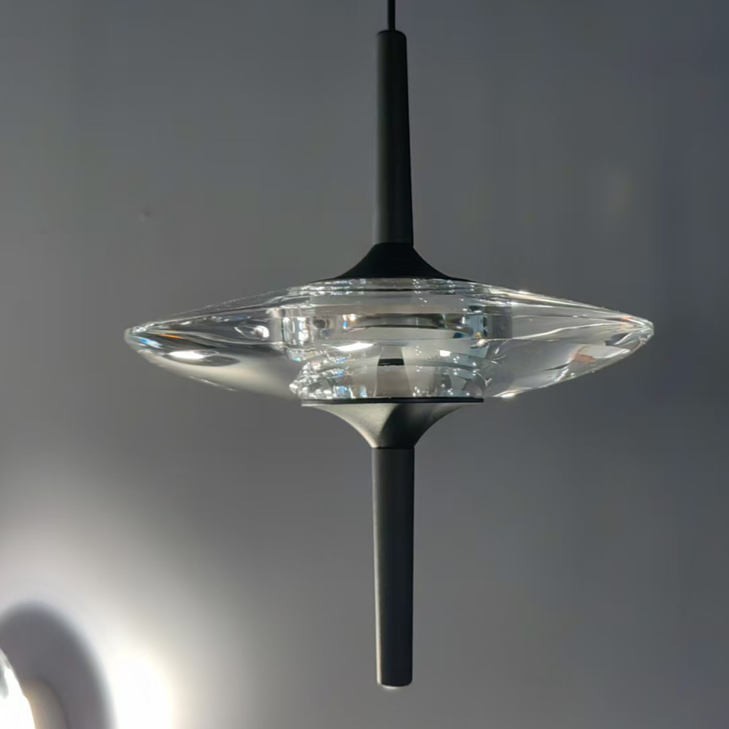 Close-up of UFO spinning-top crystal pendant light featuring optical crystal disc and matte black aluminum stem