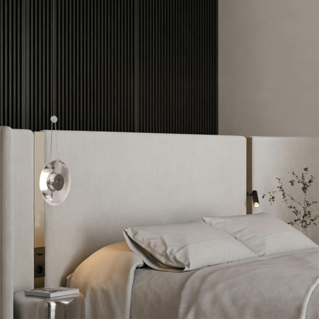 Modern minimalist pendant light featuring a clear crystal disc and polished chrome aluminum core, suspended against a clean white background.