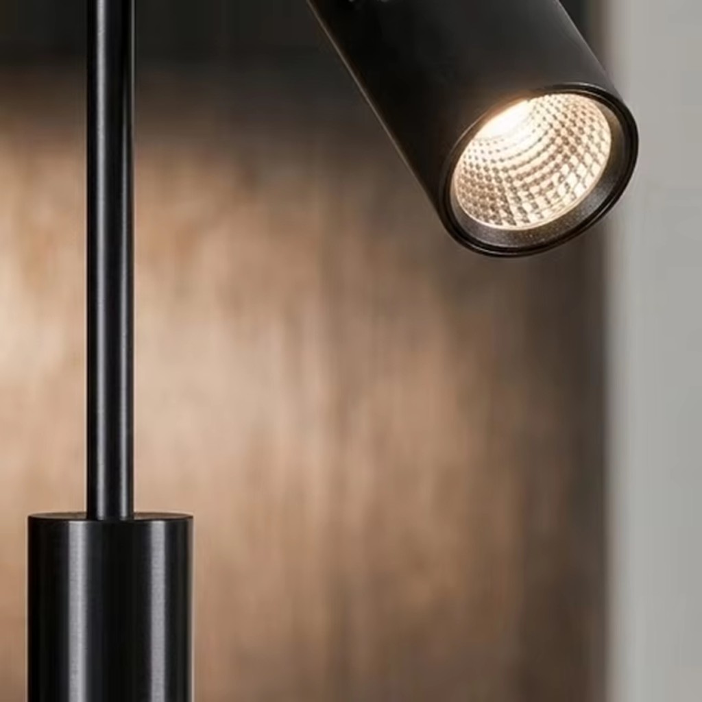 Detailed close-up of matte black aluminum spotlight head showing anti-glare reflector lens and iron connecting rod
