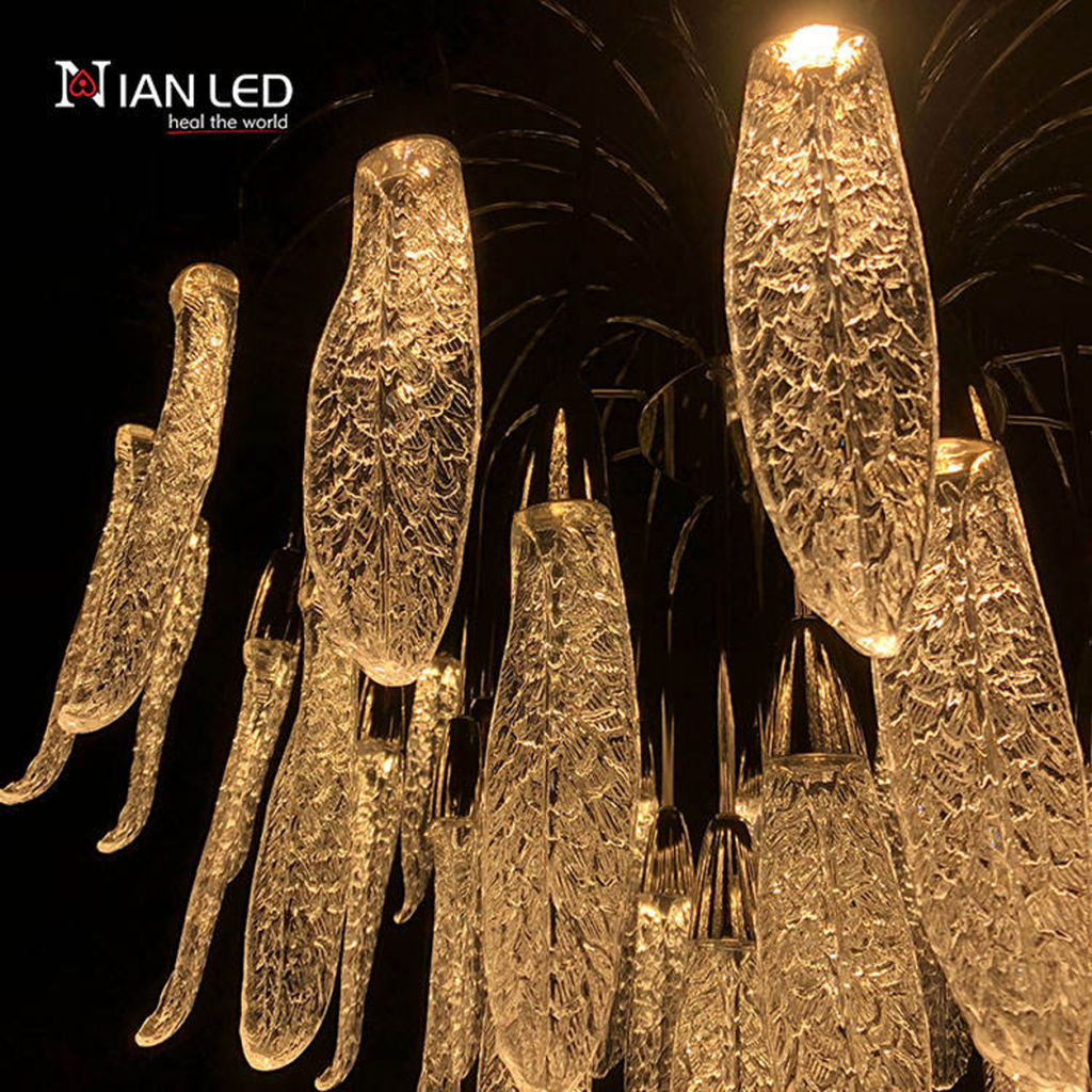 Close-up of textured optical acrylic feather leaf pods with zinc alloy hardware on a steel frame chandelier