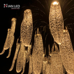 Close-up of textured optical acrylic feather leaf pods with zinc alloy hardware on a steel frame chandelier