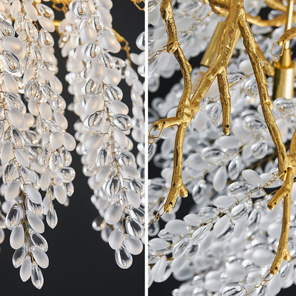 Close-up of golden textured cast aluminum branches with clear and frosted wisteria crystal drops on a luxury chandelier