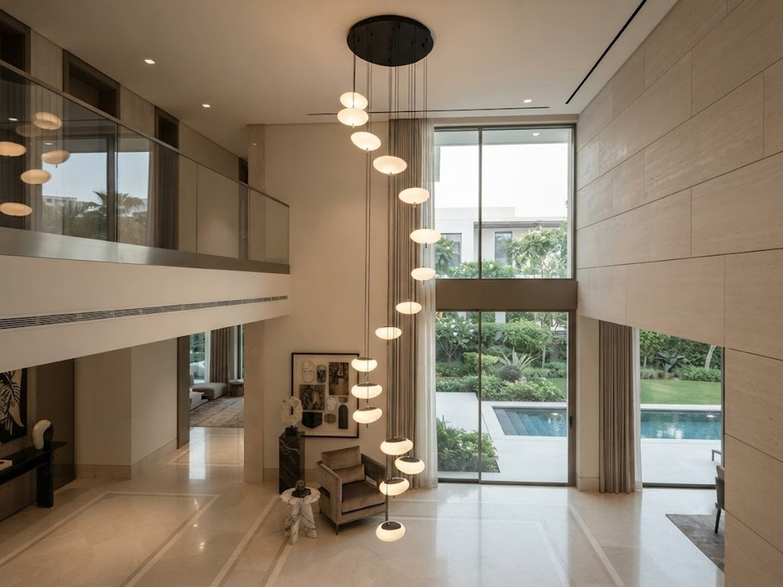 Modern spiral pebble optical acrylic staircase chandelier cascading down a high ceiling foyer