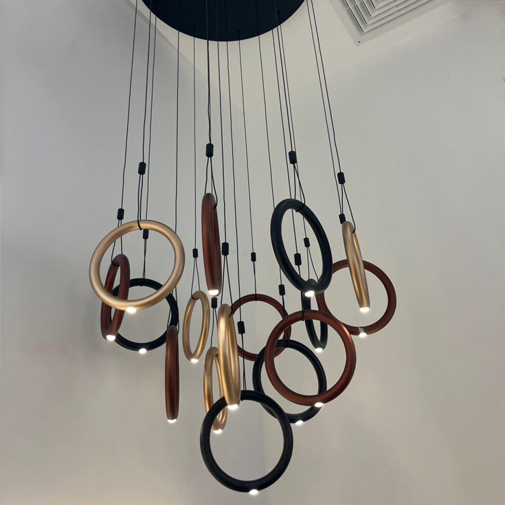 Close-up of terracotta bronze aluminum hoop ring showing smooth matte texture and suspension cable attachment