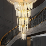 Grand cascading aluminum branch crystal chandelier installed in a double-height villa living room and foyer