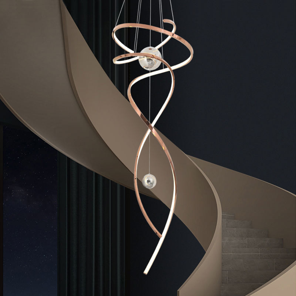 Modern rose gold stainless steel helical helix LED wave pendant light with floating orb spheres suspended in a high ceiling foyer