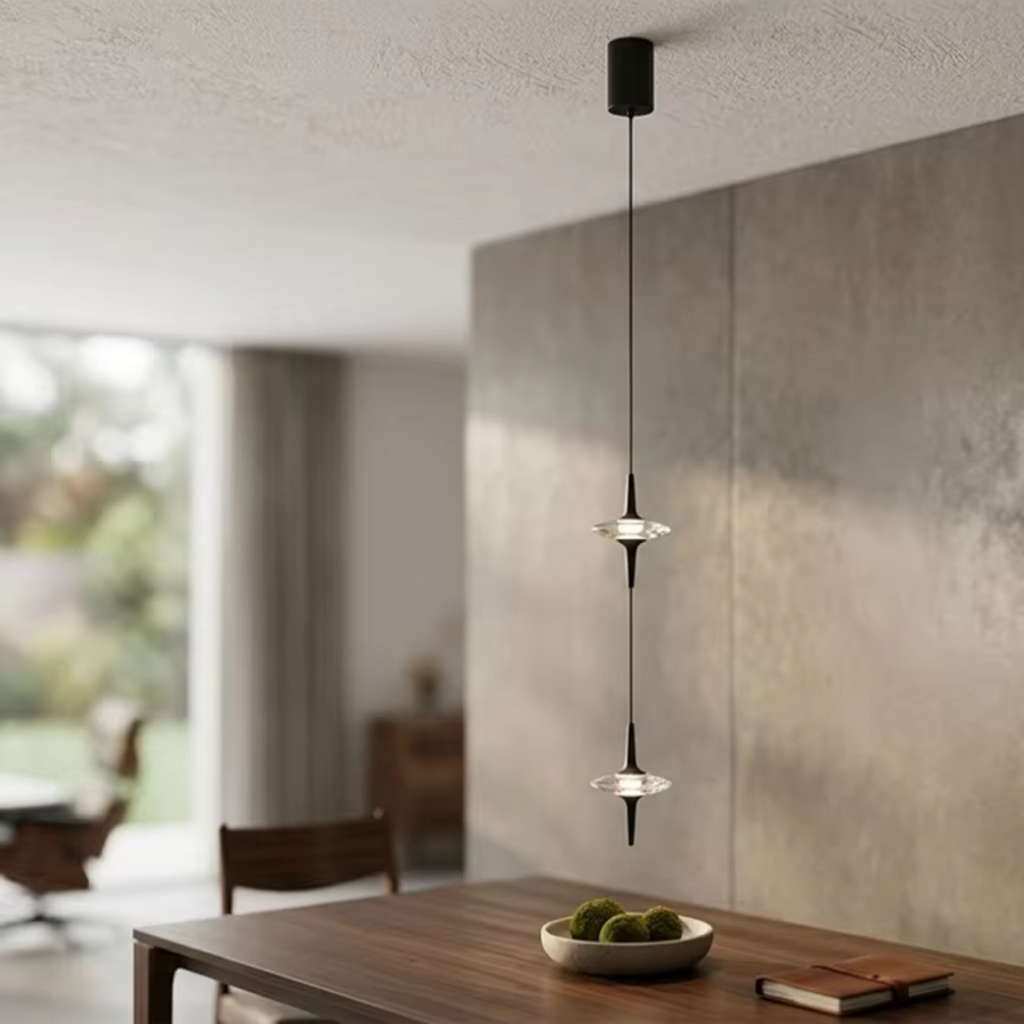 Two staggered black aluminum ufo crystal pendant lights hanging gracefully over a modern wooden dining table