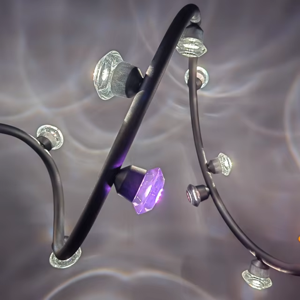 Side profile of curved black aluminum branch with luminous crystal lenses creating water-ripple light refractions