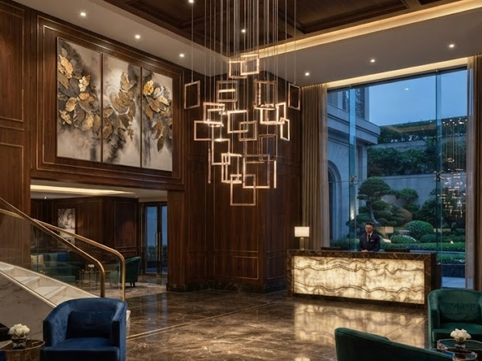 Modern rose gold stainless steel square frame cascade chandelier with mirror canopy suspended in a high ceiling foyer