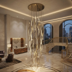 Modern gold polished stainless steel wave streamer raindrop chandelier suspended in a high ceiling villa foyer