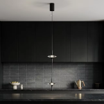 Two staggered black aluminum ufo crystal pendant lights hanging gracefully over a modern wooden dining table