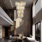 Grand cascading aluminum branch crystal chandelier installed in a double-height villa living room and foyer