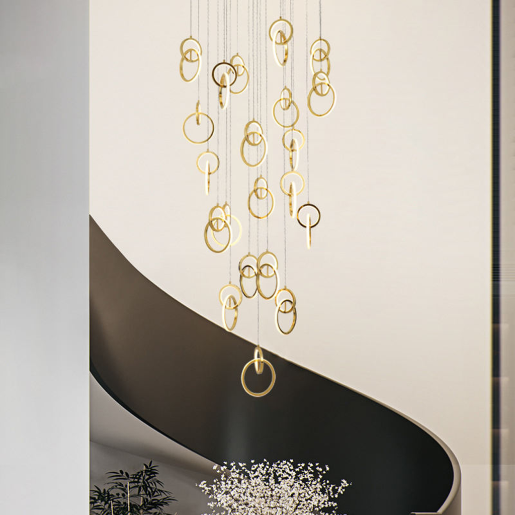 Modern gold stainless steel interlocking ring cascade chandelier suspended in a high ceiling villa foyer