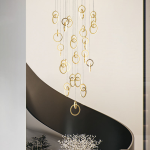 Modern gold stainless steel interlocking ring cascade chandelier suspended in a high ceiling villa foyer
