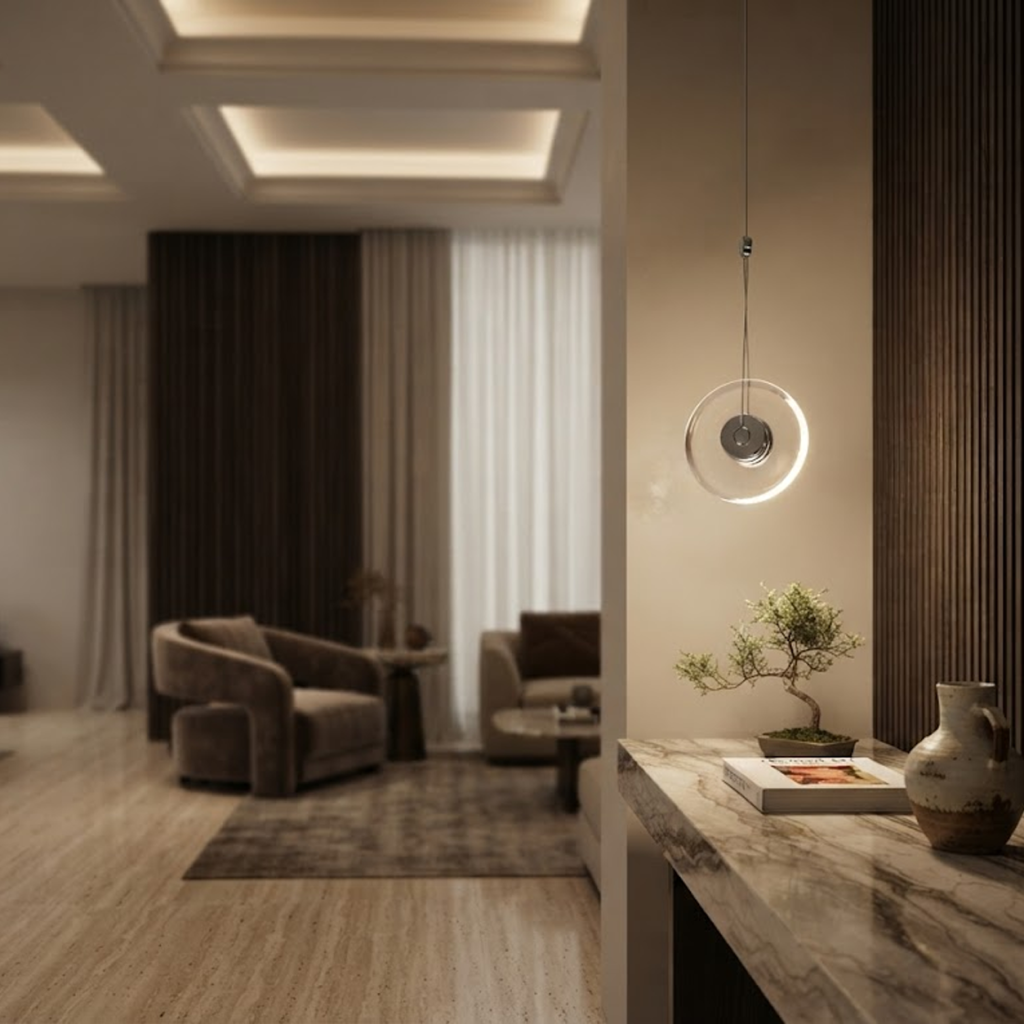 Modern minimalist pendant light featuring a clear crystal disc and polished chrome aluminum core, suspended against a clean white background.