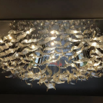 Illuminated 2400mm floating wave glass chandelier casting warm 3000K ambient glow for luxury hotel lobby