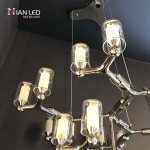 Modern multi-tiered chrome modular branching ring chandelier with tri-spoke canopy base for high ceiling living room and villa foyer
