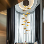 Modern luxury hand-hammered gold ginkgo leaf multi-light cascading chandelier for high ceiling staircase and duplex foyer