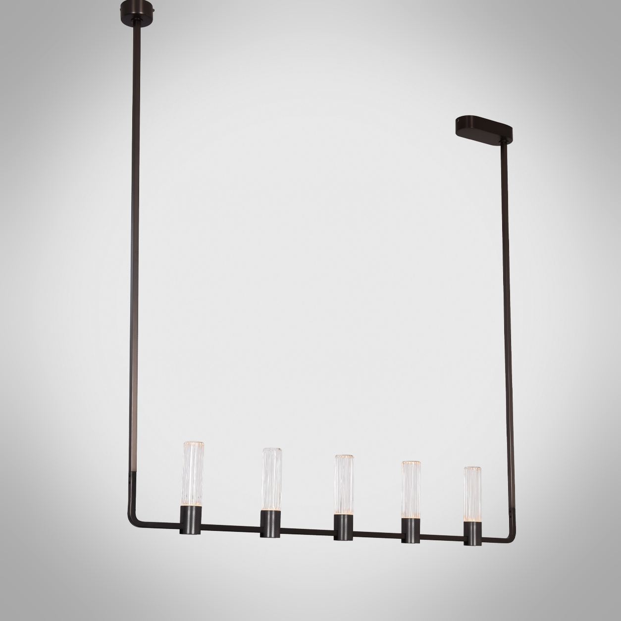 The Atelier matte black rectangular linear chandelier hanging over a wooden dining table in a luxury apartment