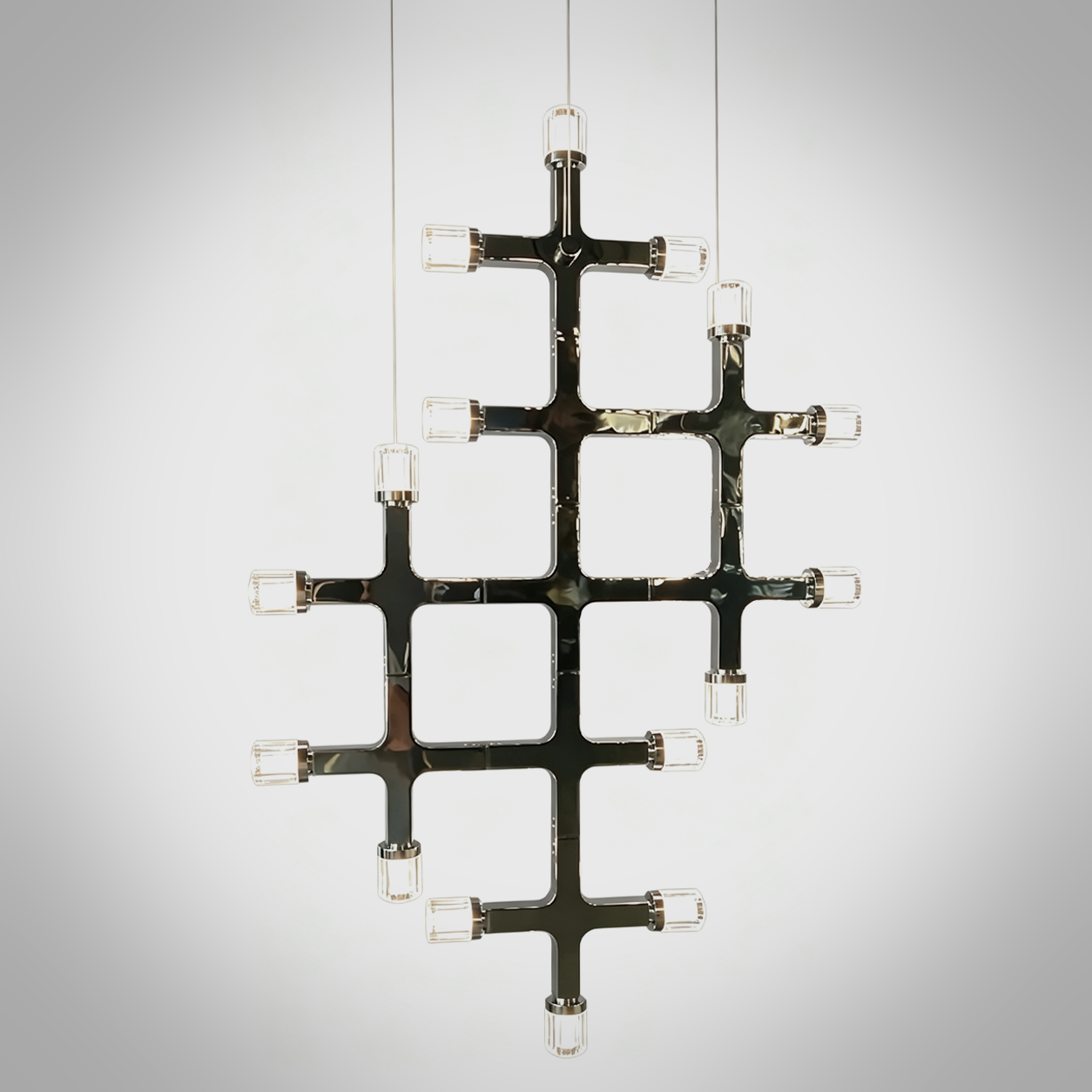 The Lattice modular chrome grid chandelier with multi directional crystal light heads hanging against wall