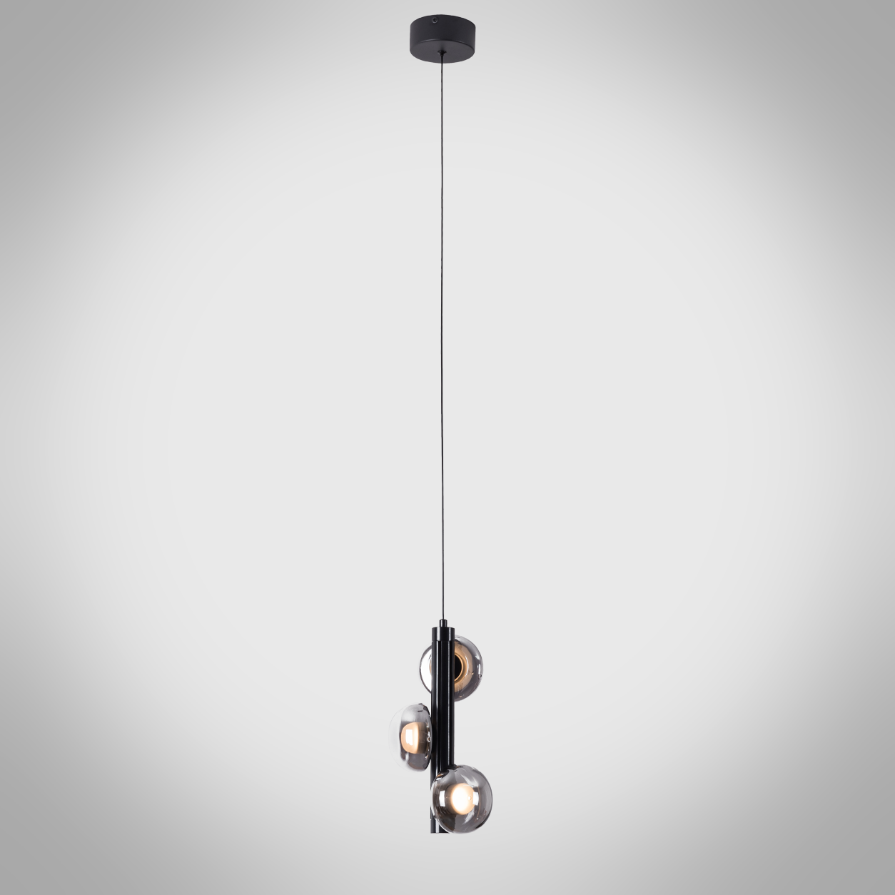 The Stellar mini pendant chandelier featuring three smoky glass orb shades on vertical black column