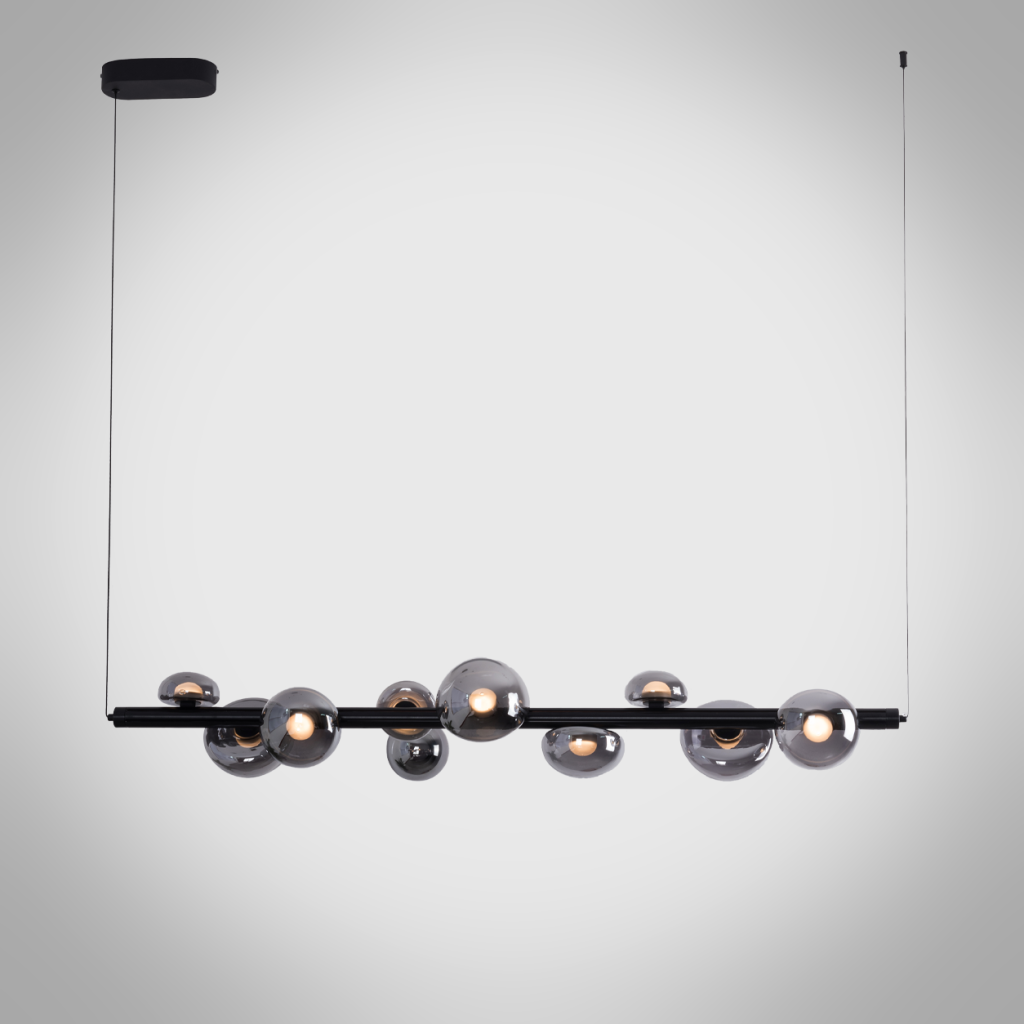 The Constellation smoky glass sphere linear chandelier hanging over a modern marble reception desk