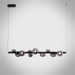 The Constellation smoky glass sphere linear chandelier hanging over a modern marble reception desk