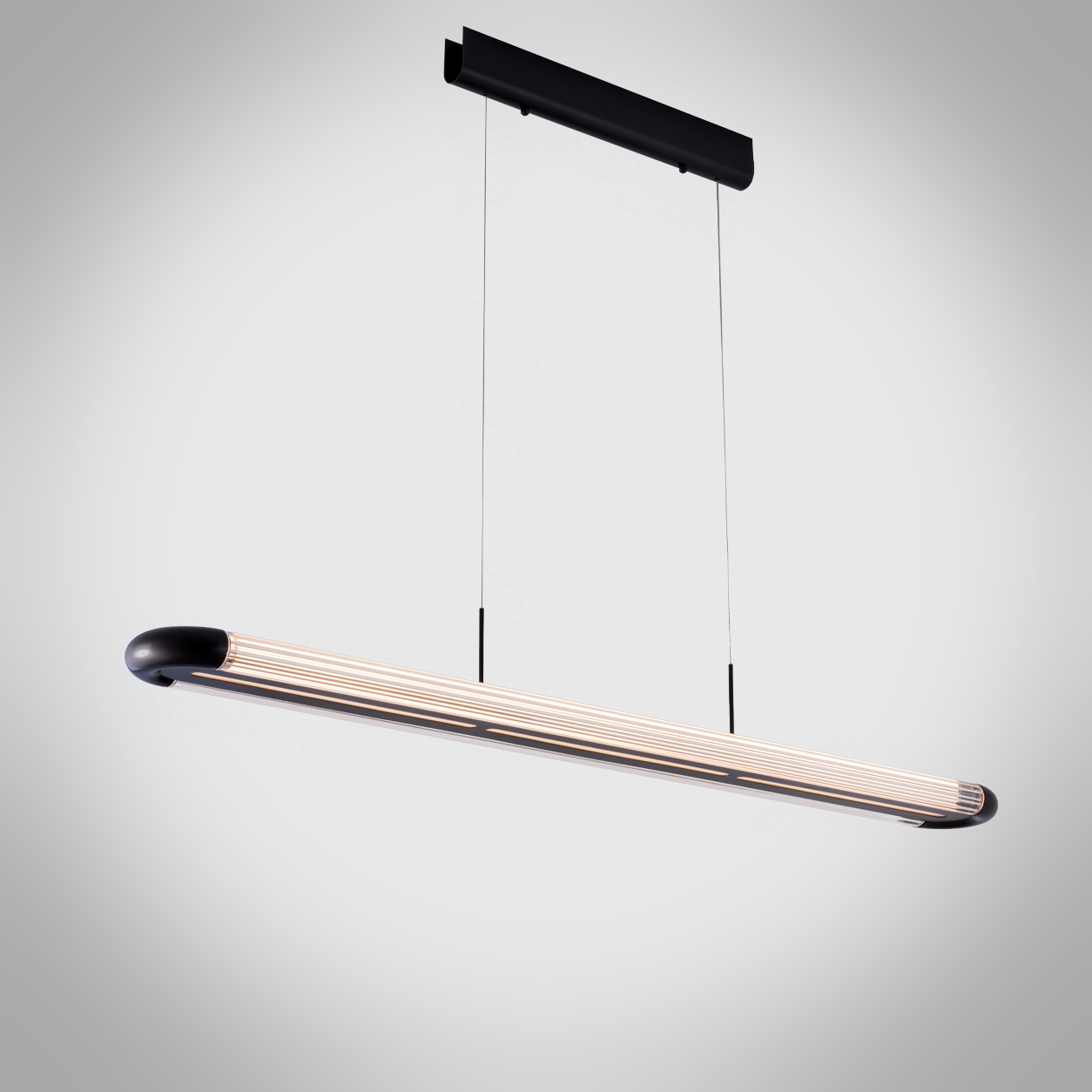 The Ray modern matte black linear pendant light with ribbed clear acrylic tube diffuser