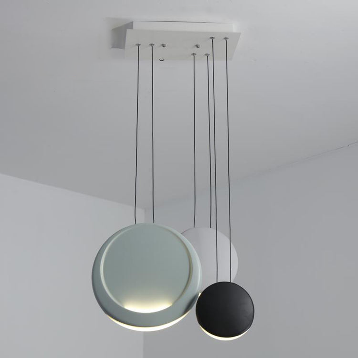Nordic cluster chandelier with pastel polyresin disc shades suspended from a white metal ceiling canopy