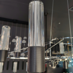Macro view of ribbed clear glass column showcasing light refraction