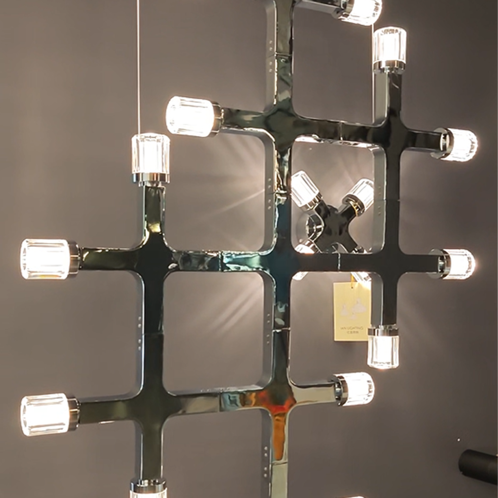 Close up of illuminated fluted glass cylinders on polished chrome grid frame
