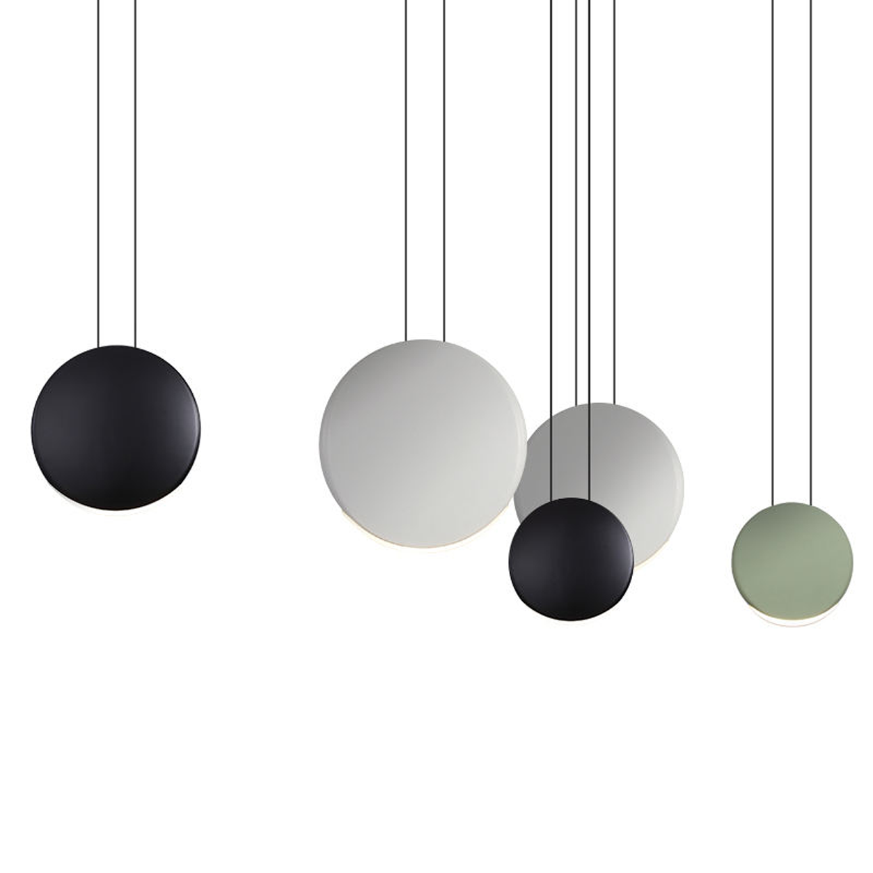 Close-up of matte grey, black, and white polyresin disc light shades showing crescent LED illumination and metal suspension cords