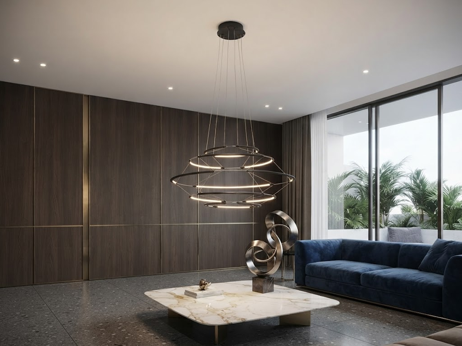 The Orbital Mesh multi tier LED ring chandelier hanging over a round dining table in a modern sunroom nook