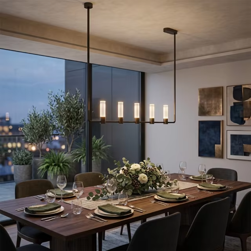 The Atelier matte black rectangular linear chandelier hanging over a wooden dining table in a luxury apartment