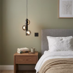 The Stellar mini pendant chandelier featuring three smoky glass orb shades on vertical black column