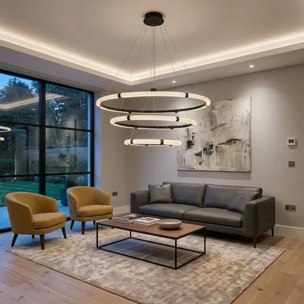 The Aura 3 tier fluted acrylic LED ring chandelier hanging in a modern double height ceiling living room