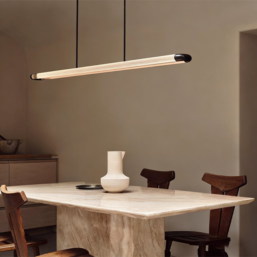 The Ray fluted acrylic linear LED pendant light suspended over a large marble dining table in a luxury home