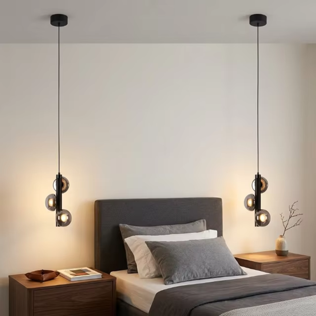 The Stellar mini pendant chandelier featuring three smoky glass orb shades on vertical black column