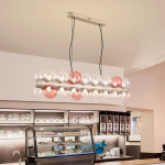 The Cell linear glass globe bubble chandelier with champagne gold textured core and pink accent globes