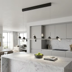 The Metro linear adjustable spotlight chandelier suspended over a modern marble kitchen island